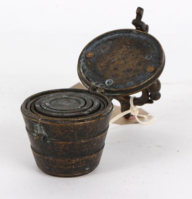 Lot 387 - An early set of nested brass cup weights