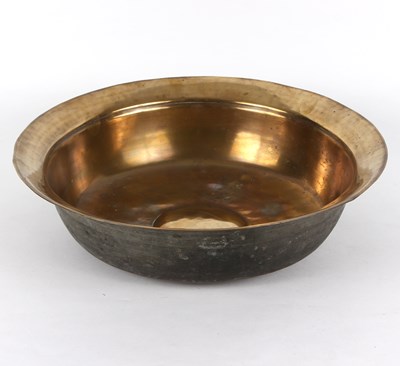 Lot 390 - A bossed brass bowl, circa 1700, 45.75cm diameter