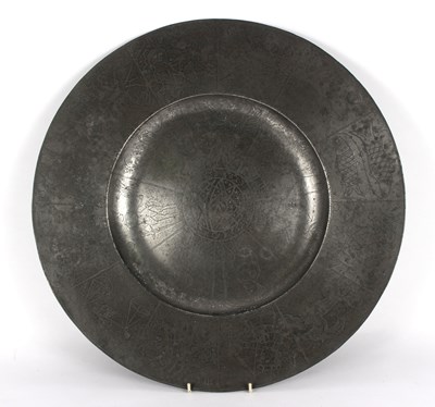 Lot 399 - A broad rimmed pewter charger, by RC, naively...