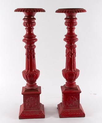 Lot 433 - A pair of red painted cast iron pricket...