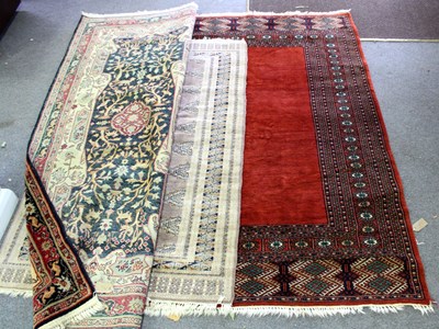 Lot 480 - Three Eastern rugs, the largest with a plain...