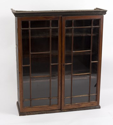 Lot 514 - A mahogany bookcase, enclosed by a pair of...