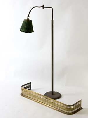 Lot 523 - An adjustable reading lamp and a brass fire curb