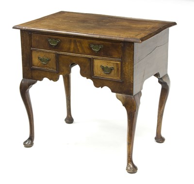 Lot 550 - A George III walnut and feather banded lowboy,...