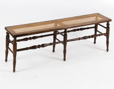 Lot 578 - A cane seated window seat, on turned legs and...