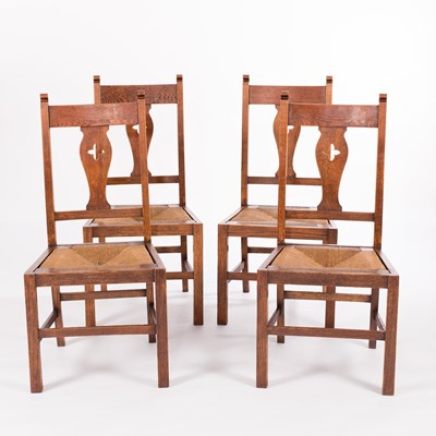 Lot 595 - Four oak dining chairs with drop-in rush seats...