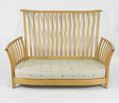 Lot 1008 - An Ercol two-seater sofa with slatted back,...