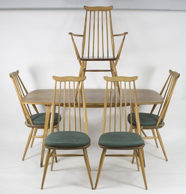 Lot 1011 - An Ercol dining table, five chairs and one carver