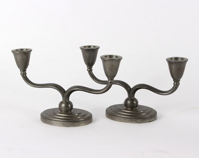 Lot 1028 - A pair of pewter two-branch candlesticks by...