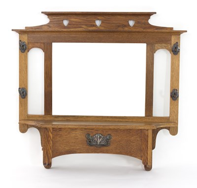 Lot 1042 - An Art Nouveau oak hall mirror with coat pegs...