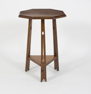 Lot 1044 - An Art Nouveau oak table, the octagonal top on...