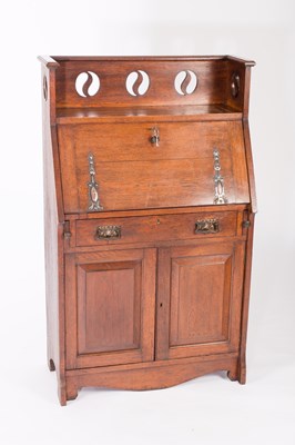 Lot 1047 - An Art Nouveau oak bureau, the galleried top...