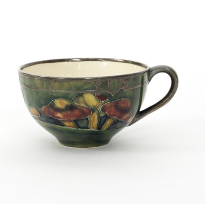 Lot 1065 - A Moorcroft Claremont teacup with silver...