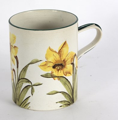 Lot 1073 - A Wemyss mug painted daffodils within green...