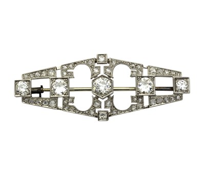 Lot 1144 - An Art Deco diamond brooch centred a round...