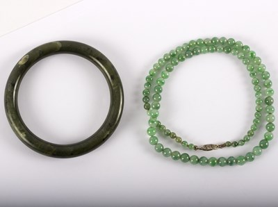 Lot 1161 - A jade single-row beaded necklace and a...