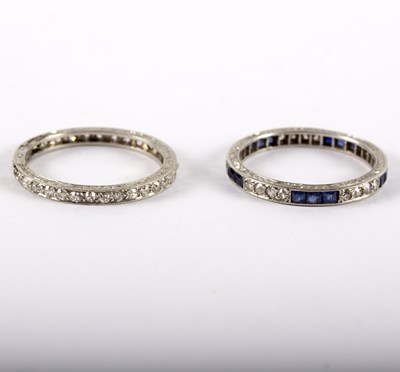 Lot 1165 - A sapphire and diamond eternity ring to a...