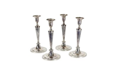 Lot 1336 - A set of four George III silver candlesticks,...