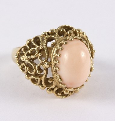 Lot 23 - A pink and coral dress ring of modern design,...