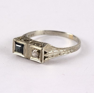 Lot 27 - A diamond and sapphire two-stone ring in a...