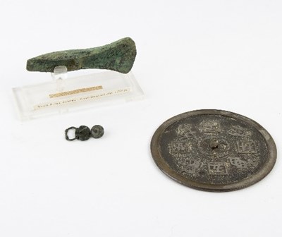 Lot 263 - A bronze axe head, a Chinese metal mirror, a...