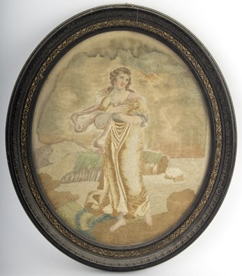 Lot 274 - A Georgian oval silkwork picture of a woman in...