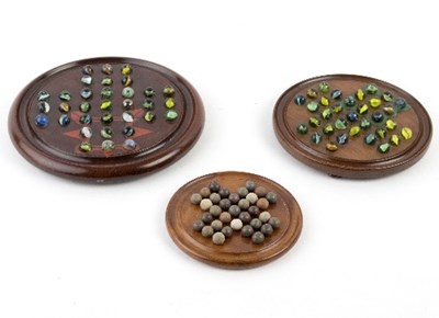 Lot 290 - A wooden solitaire board and marbles, 27cm...