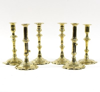 Lot 318 - Two pairs of petal based brass candlesticks...