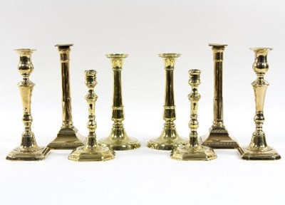 Lot 319 - A pair of George III brass candlesticks with...