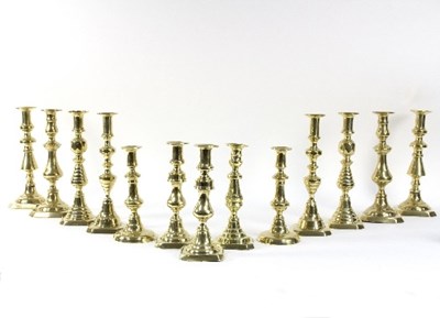 Lot 324 - Five pairs of baluster brass candlesticks and...