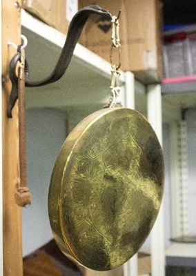 Lot 329 - A small brass gong with snake support, the...