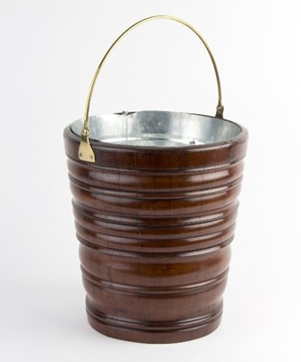 Lot 451 - A turned wood bucket, with brass swing handle,...