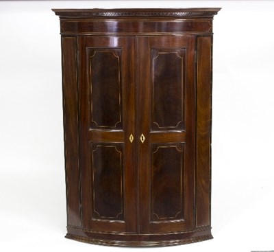 Lot 891 - A mahogany and inlaid bowfront corner cabinet...