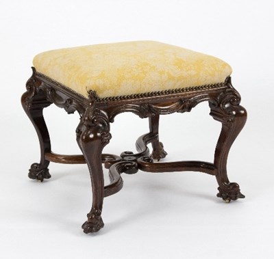 Lot 937 - A walnut upholstered stool, with carved scroll...