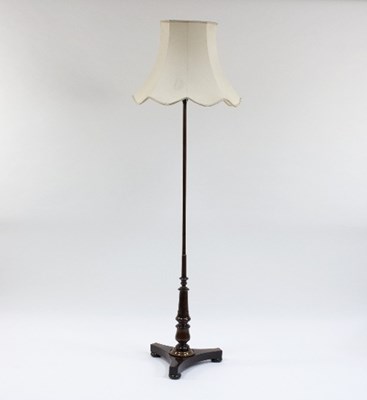 Lot 940 - A rosewood standard lamp on a turned column...