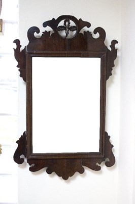 Lot 964 - A mahogany wall mirror, the frame with carved...