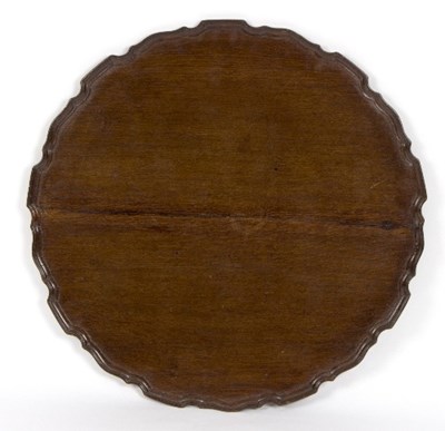 Lot 978 - A mahogany circular table top with pie-crust...