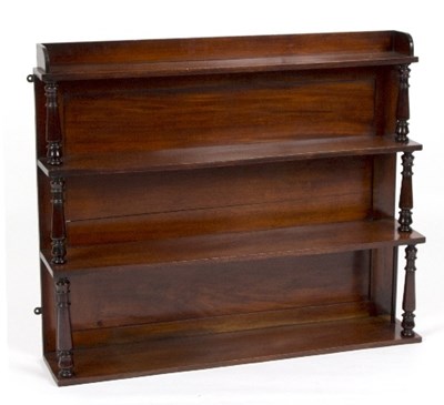 Lot 983 - A mahogany hanging shelf with turned supports...