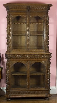 Lot 1011 - A carved oak display cabinet of Classical...