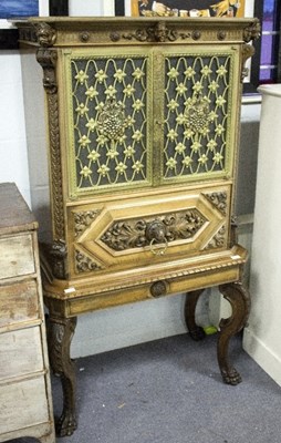 Lot 1018 - An Italian carved walnut cocktail cabinet with...