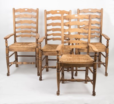 Lot 1088 - A set of four ladder back chairs with rush...