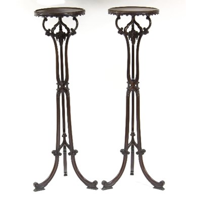 Lot 1089 - A pair of Chippendale style mahogany torcheres,...