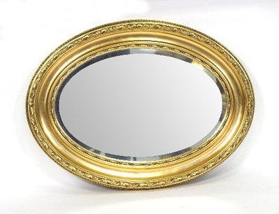 Lot 1114 - An oval gilt framed mirror, the bevelled glass...