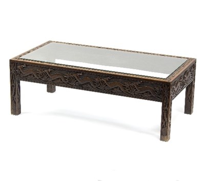 Lot 1131 - A glass topped coffee table with carved frieze...