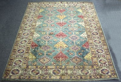 Lot 1190 - A Kazak rug worked in blue, brown and red,...