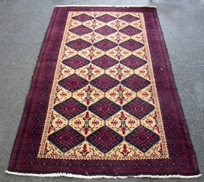 Lot 1215 - A North West Persian Rug, three rows of seven...