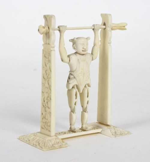 Lot 56 - A Chinese carved ivory toy figure of an...
