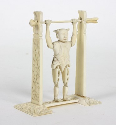 Lot 56 - A Chinese carved ivory toy figure of an...