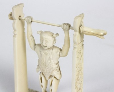 Lot 56 - A Chinese carved ivory toy figure of an...