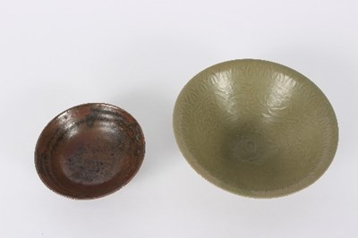 Lot 64 - A celadon incised bowl decorated...